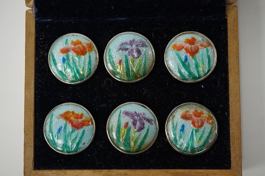 An early 20th century cased set of 6 Japanese white metal buttons, enamelled with irises, 22mm. Condition - good